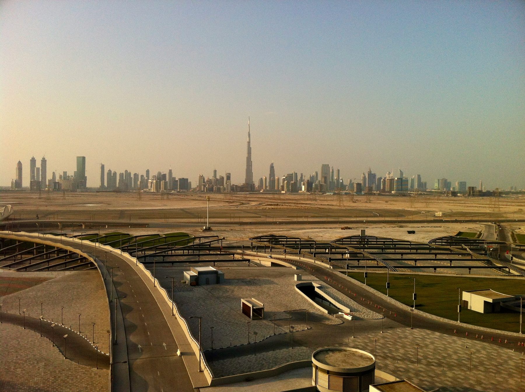 Aerial view of Dubai's coast with the Burj Al Arab, the city stretching inland toward Downtown